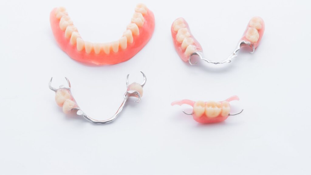 A preview of dentures including a complete, and three types of partial dentures